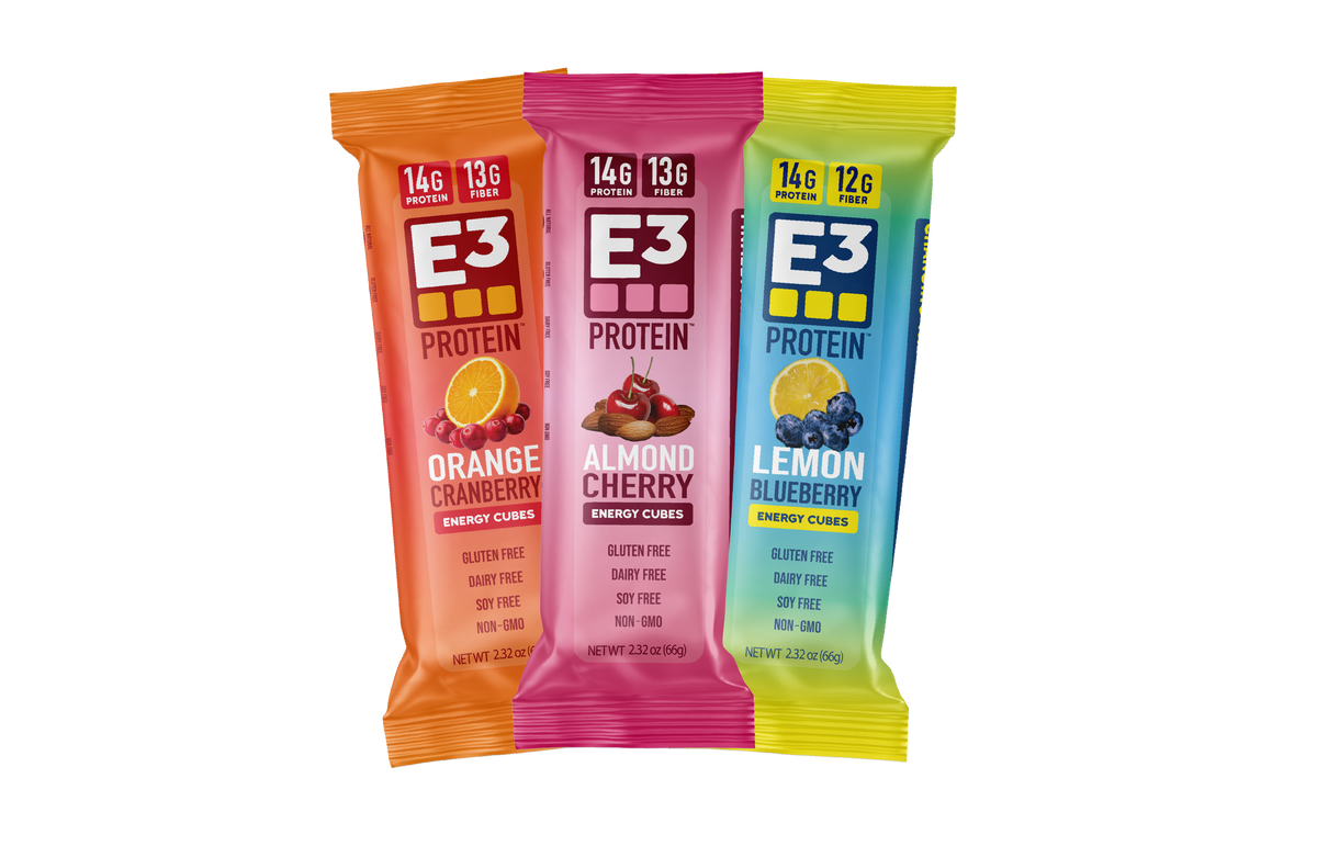 E3 Protein bars by E3 Energy Cubes showing the bars that are included in the fruit fanatic variety packLeft to right, orange cranberry, almond cherry, and lemon blueberry
